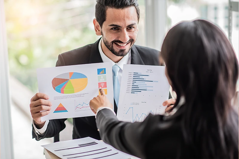 business woman pointing at reports